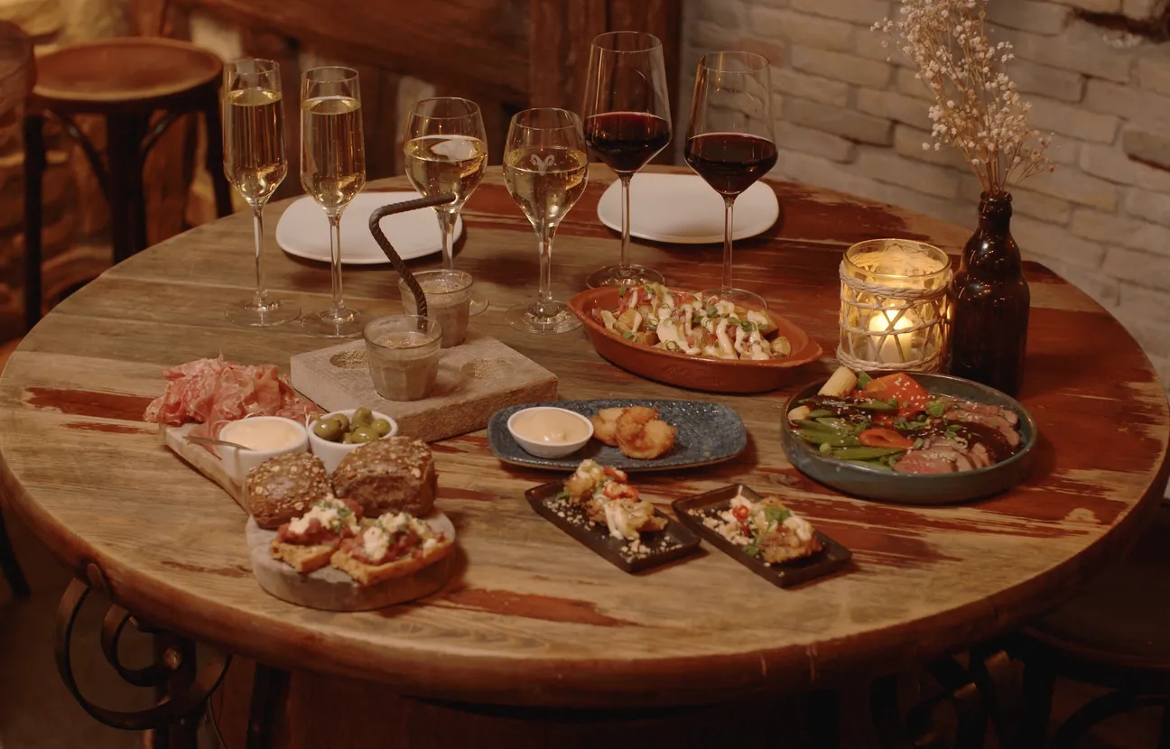 Table with glasses of wine and tasty snacks