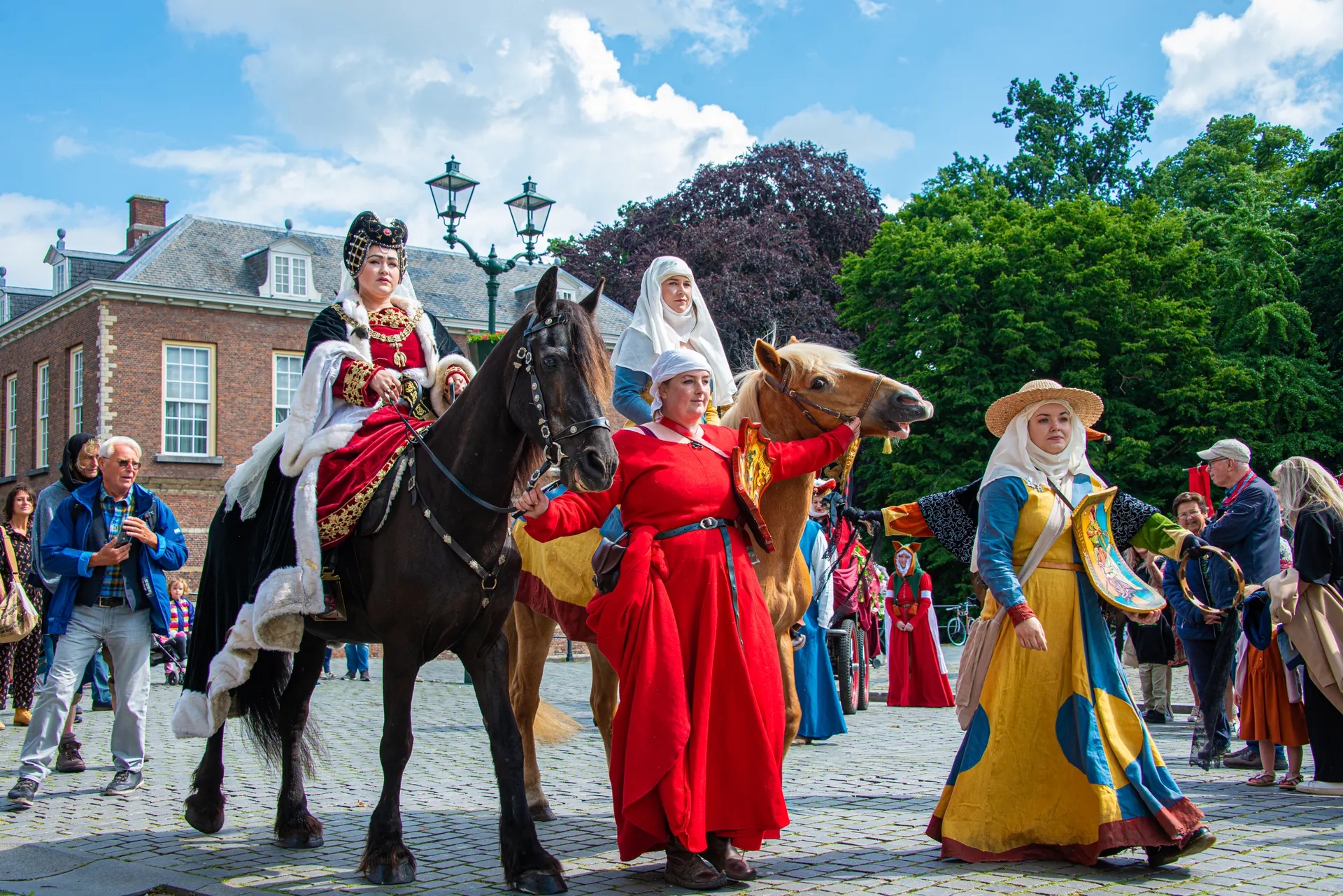 People dressed in the theme of Nassaudag riding a horse.