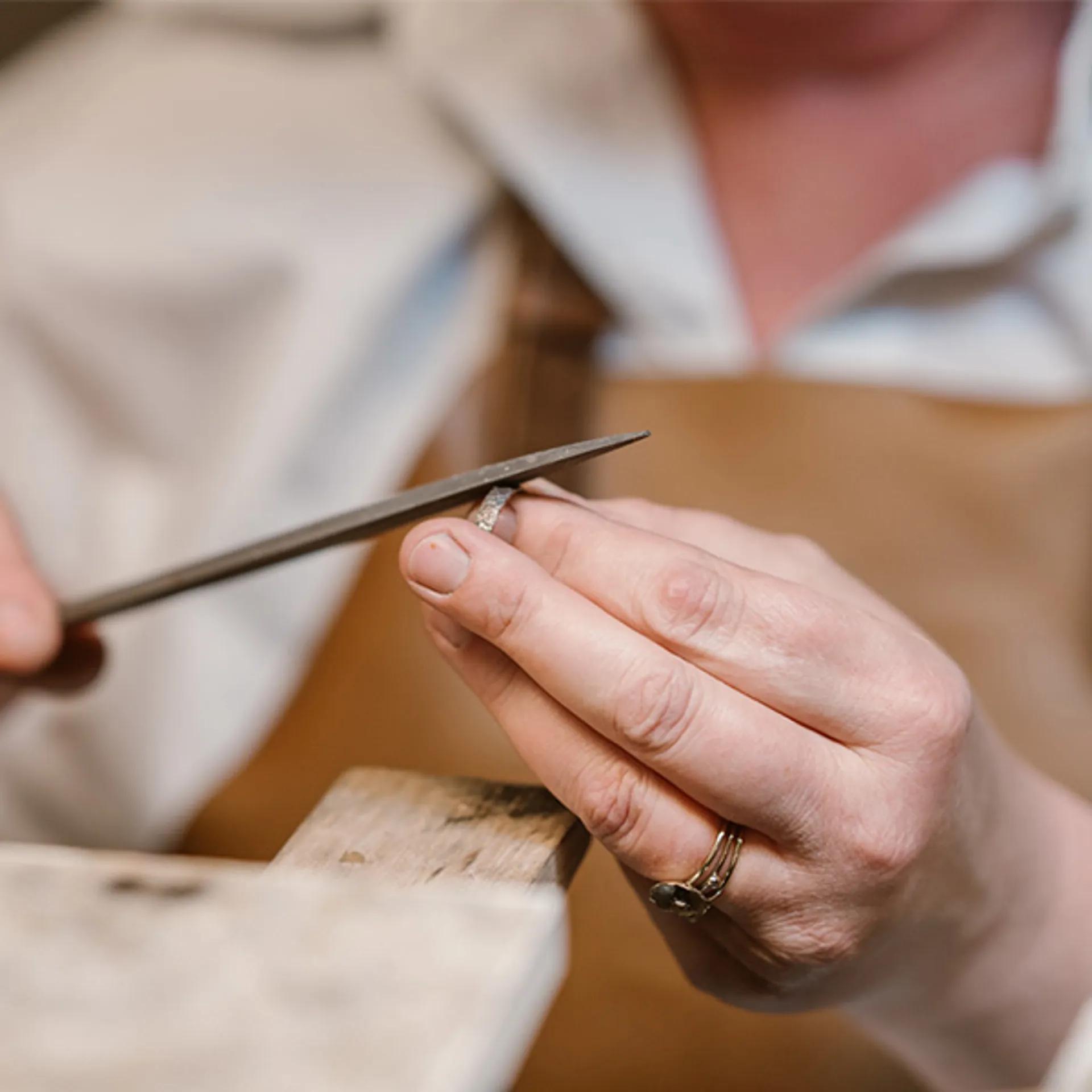someone who restores a piece of jewelry.
